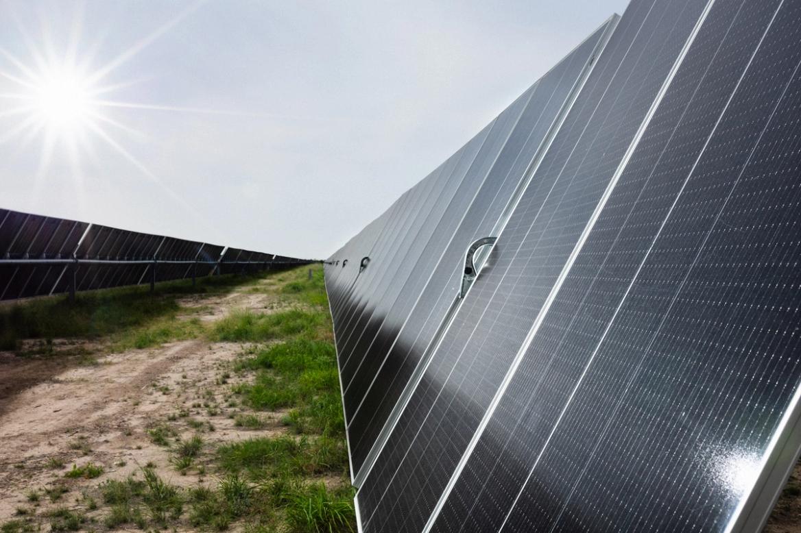 Solar PV array under blue sky with installed electrical infrastructure