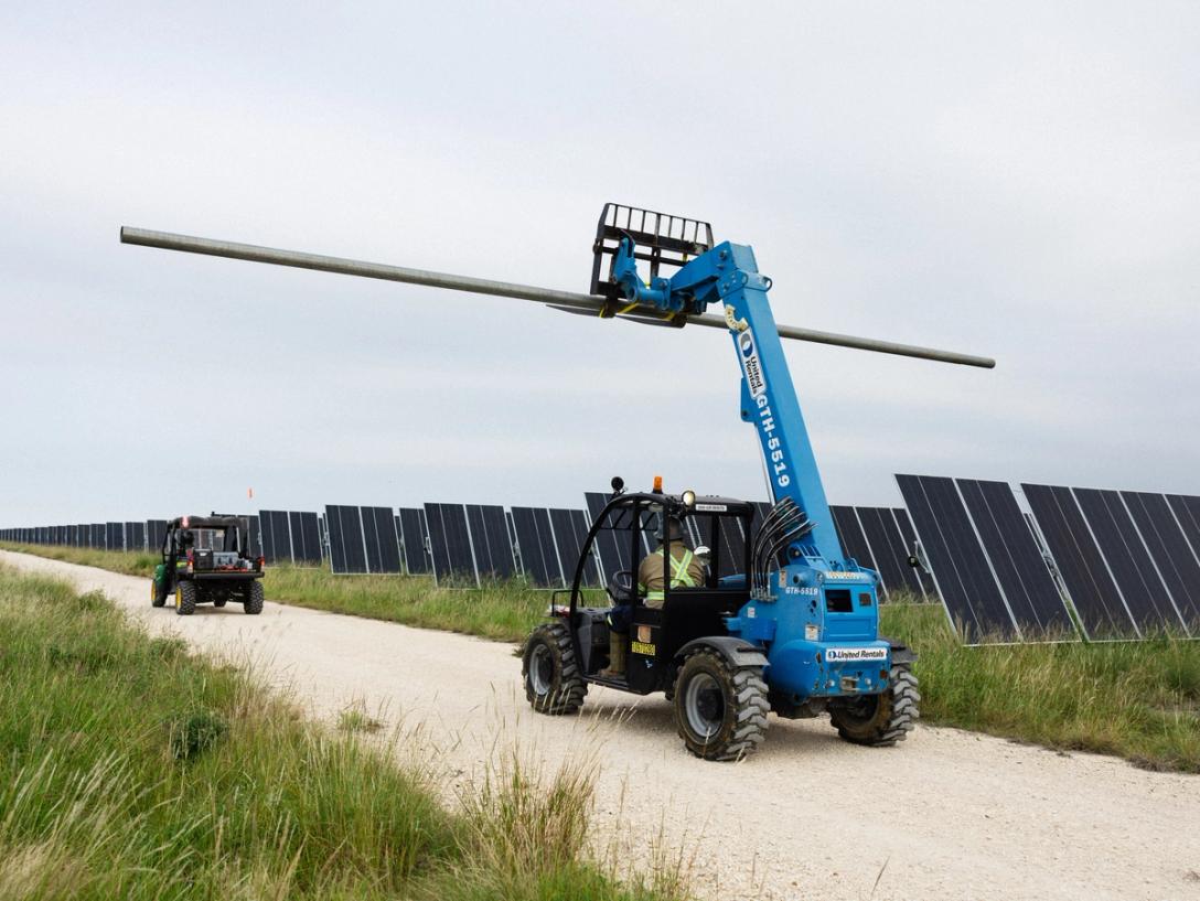 Solar installation crew with trenching equipment on site