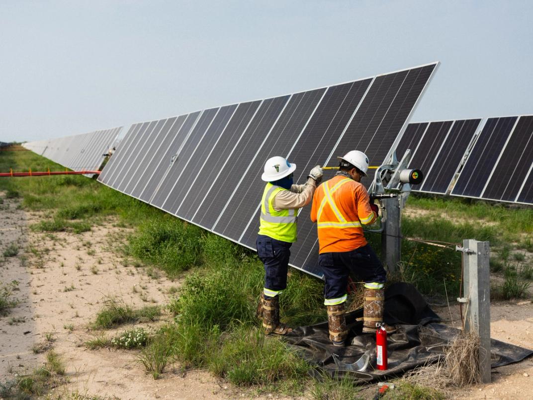 Solar installation crew with trenching equipment on site