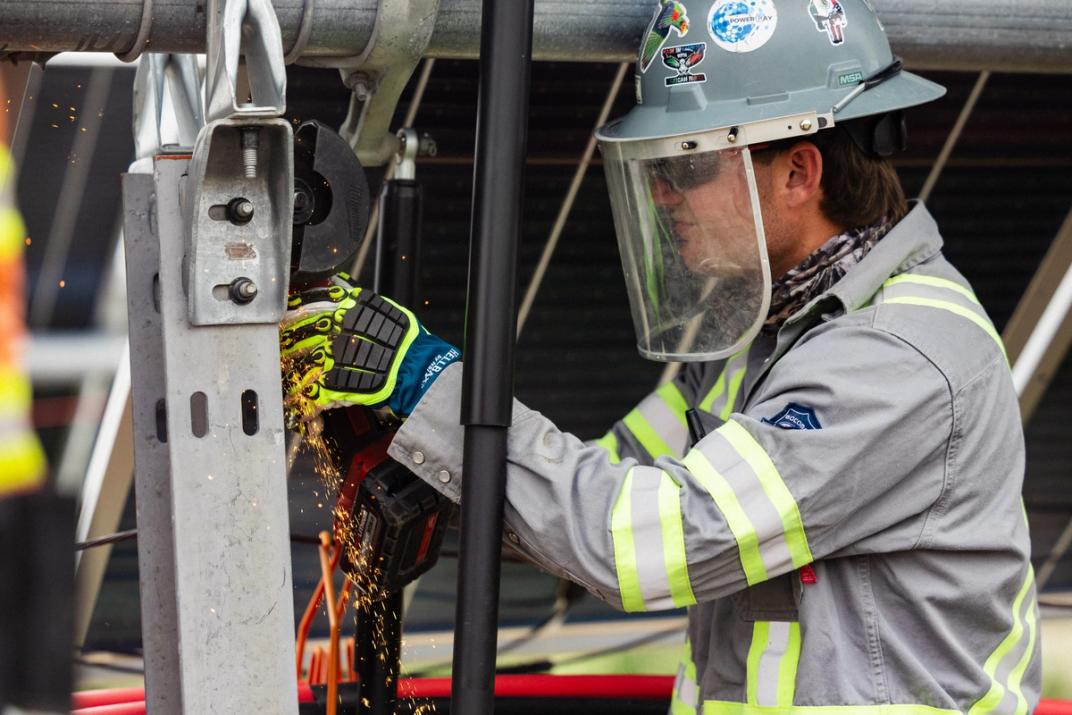 Electrician working on a utility-scale solar inverter station