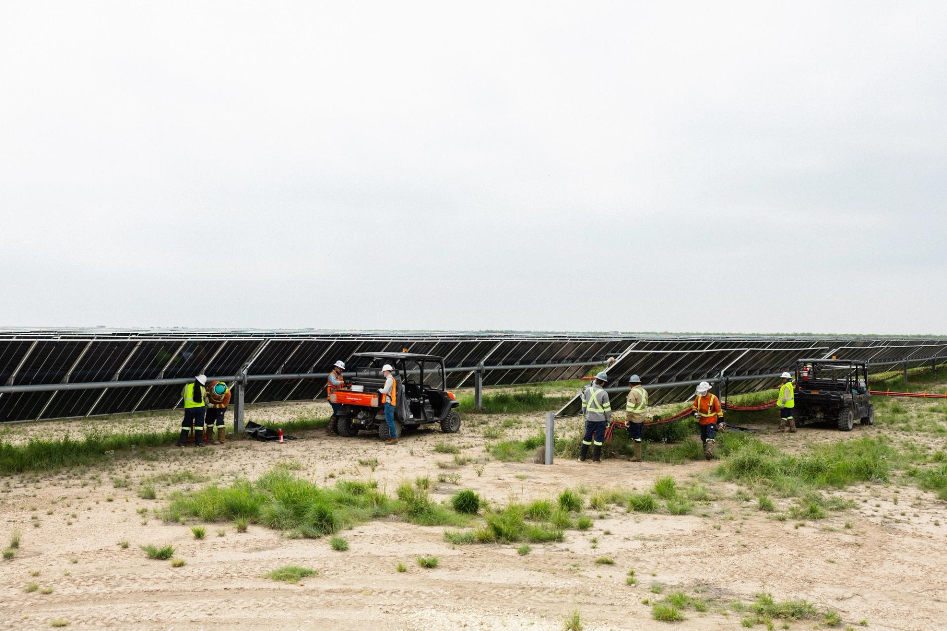 Crew installing solar modules on a utility-scale solar field
