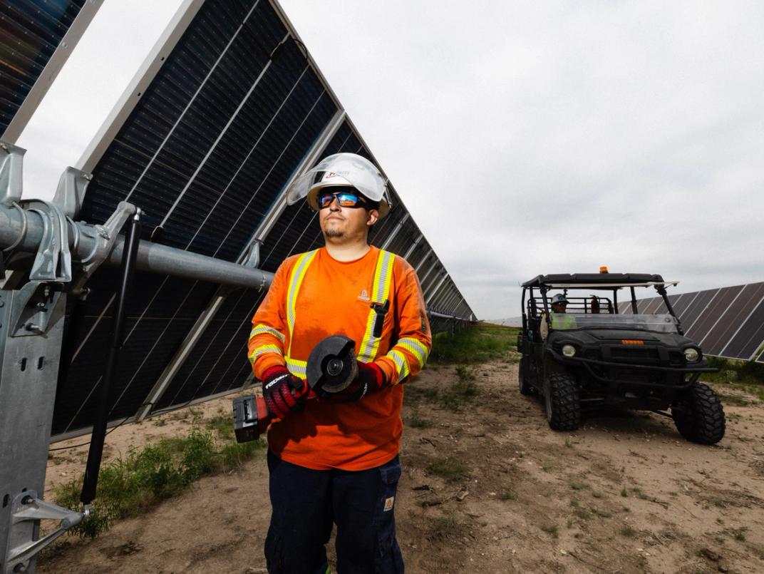 Solar construction crew at dusk on a utility-scale site