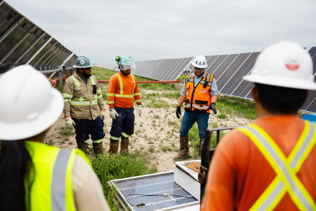 Solar crew member working on a utility-scale field