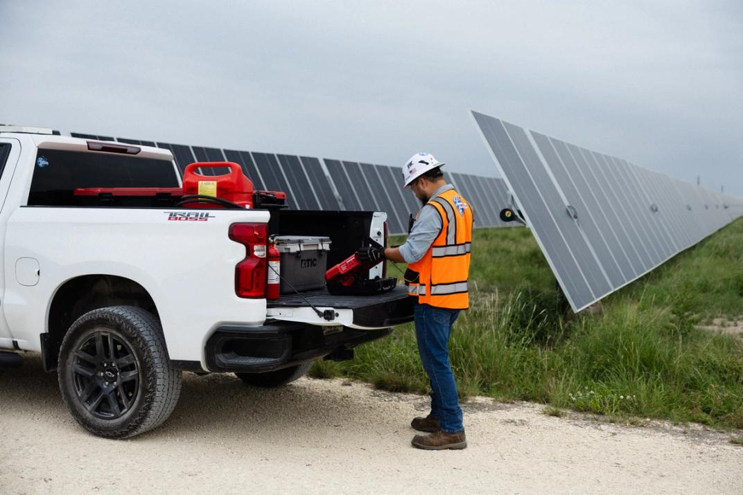 Solar crews installing modules on a utility-scale field