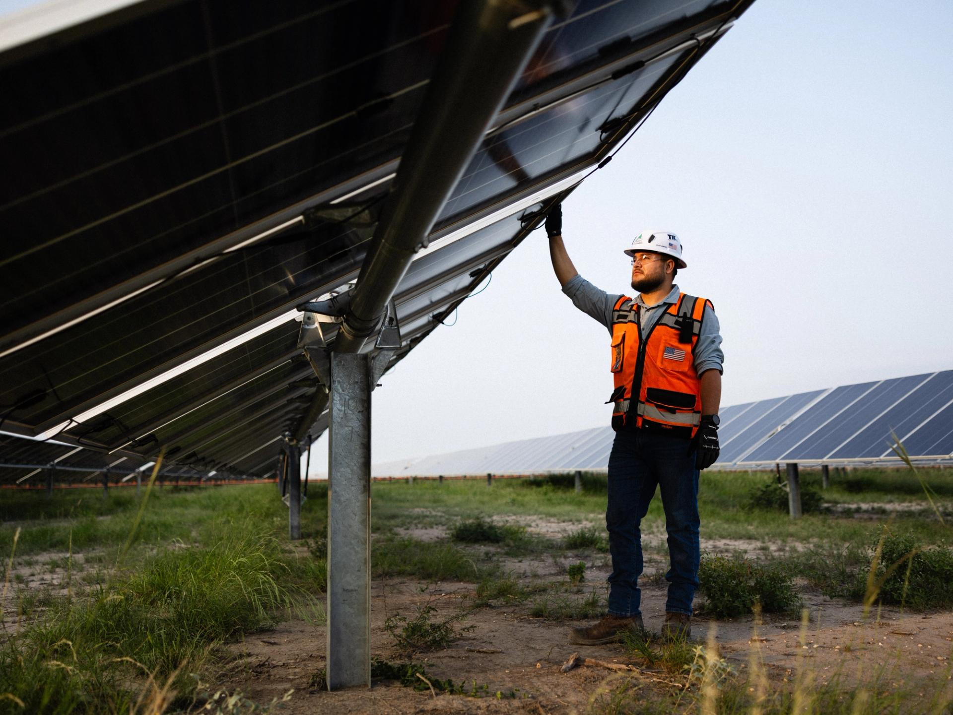 Power Ray crew on a utility-scale solar construction site at dusk