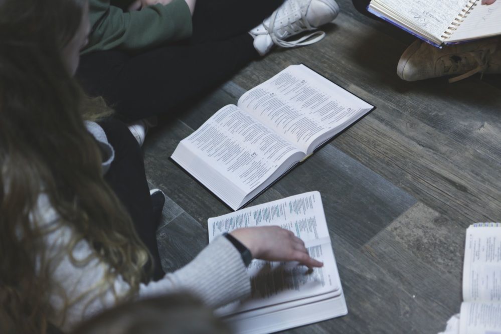 Open Bibles and journals during a study