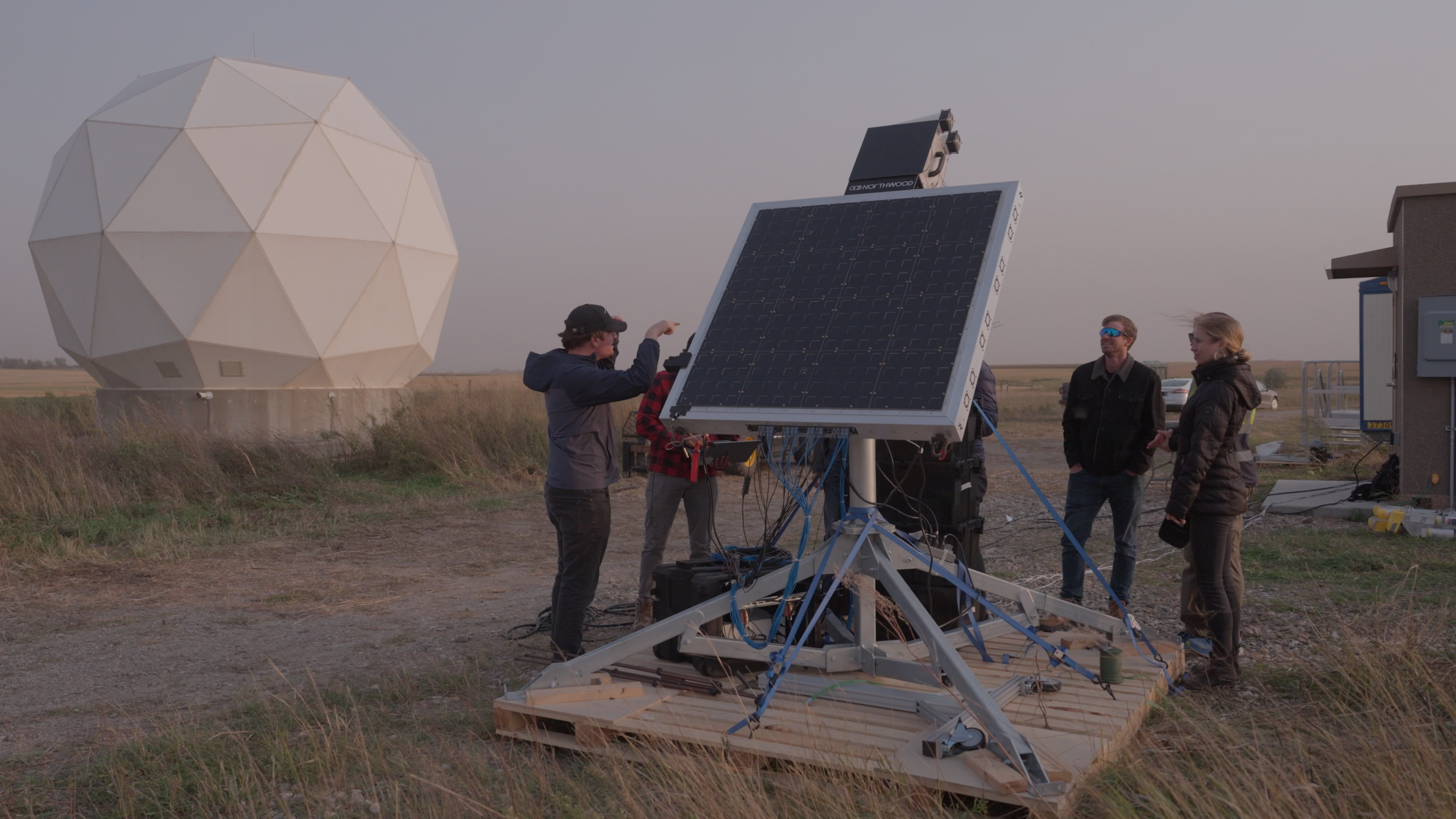 An image of people setting up a satellite communication system