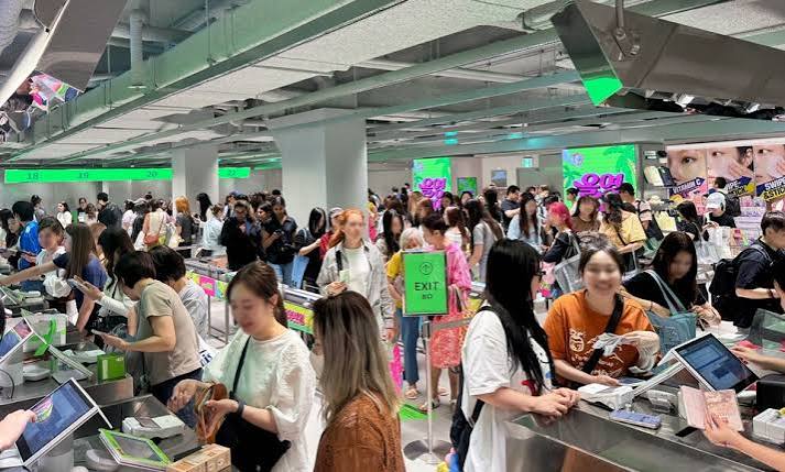 International shoppers browsing beauty products at Olive Young in Korea