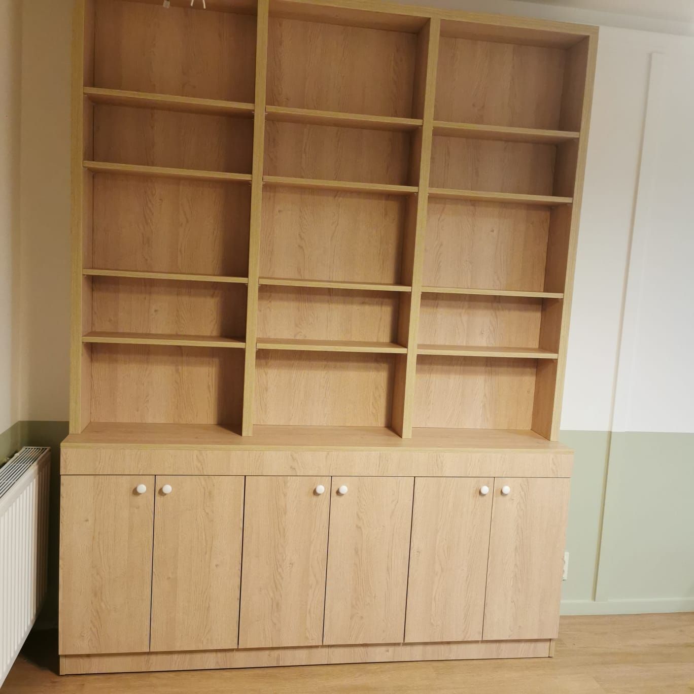 Biblioteka salonowa do sufitu z otwartymi półkami i dolnymi szafkami