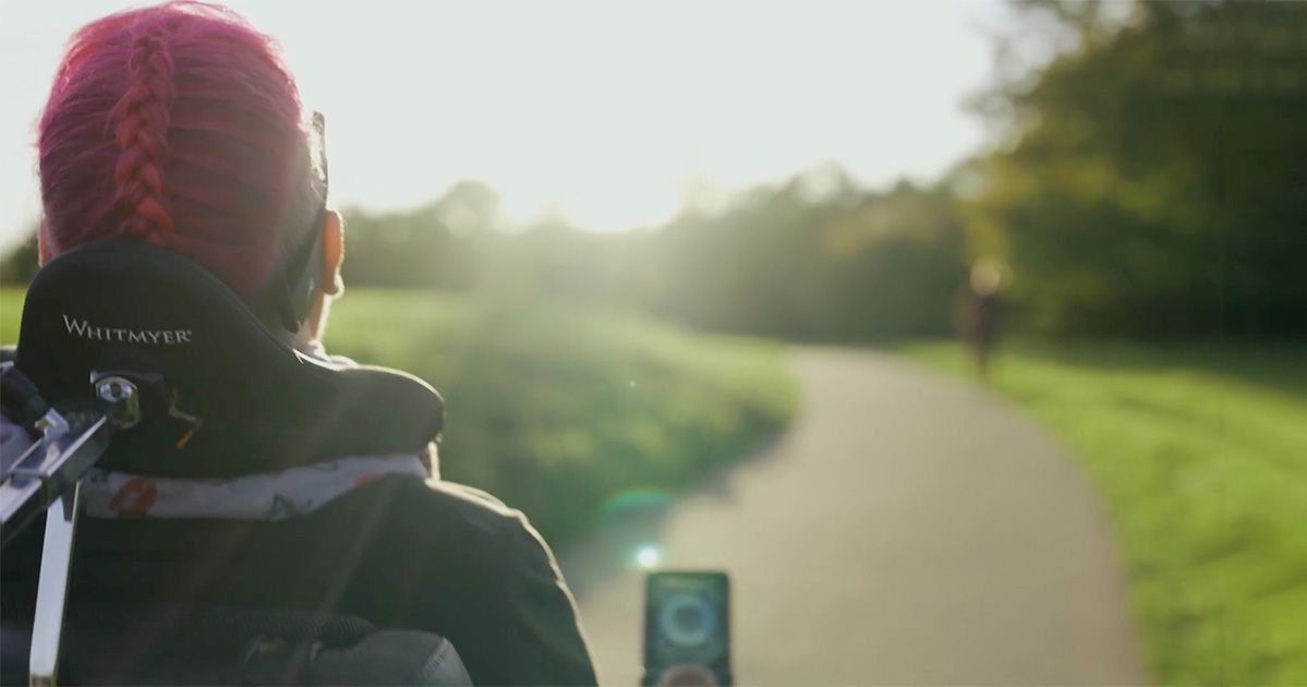 Head control for a woman in a wheelchair Head control for a woman in a wheelchair with pink hair
