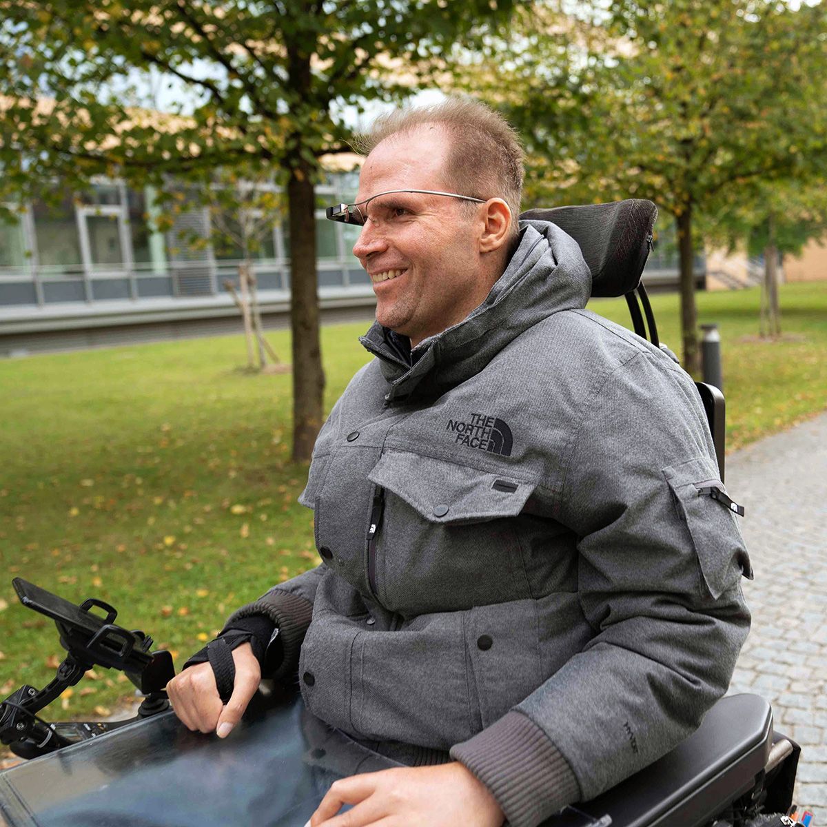 Ein Munevo-Nutzer genießt eine Fahrt durch den Park in seinem Rollstuhl