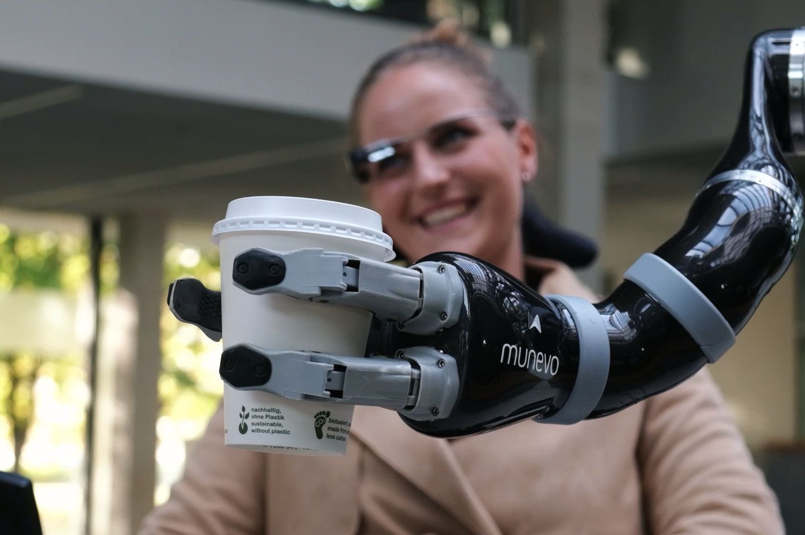 munevo user grabbing a coffee with munevo arm