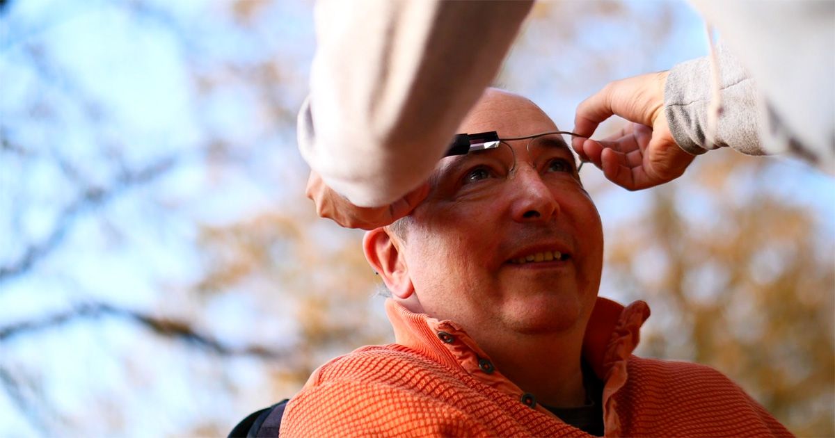 Head control for man in wheelchair Head control for man in wheelchair with orange sweater