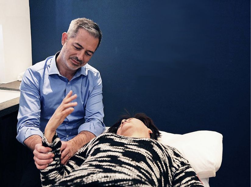 Dr Damien Mouellic treating a patient at his clinic Central & Stanley Wellness