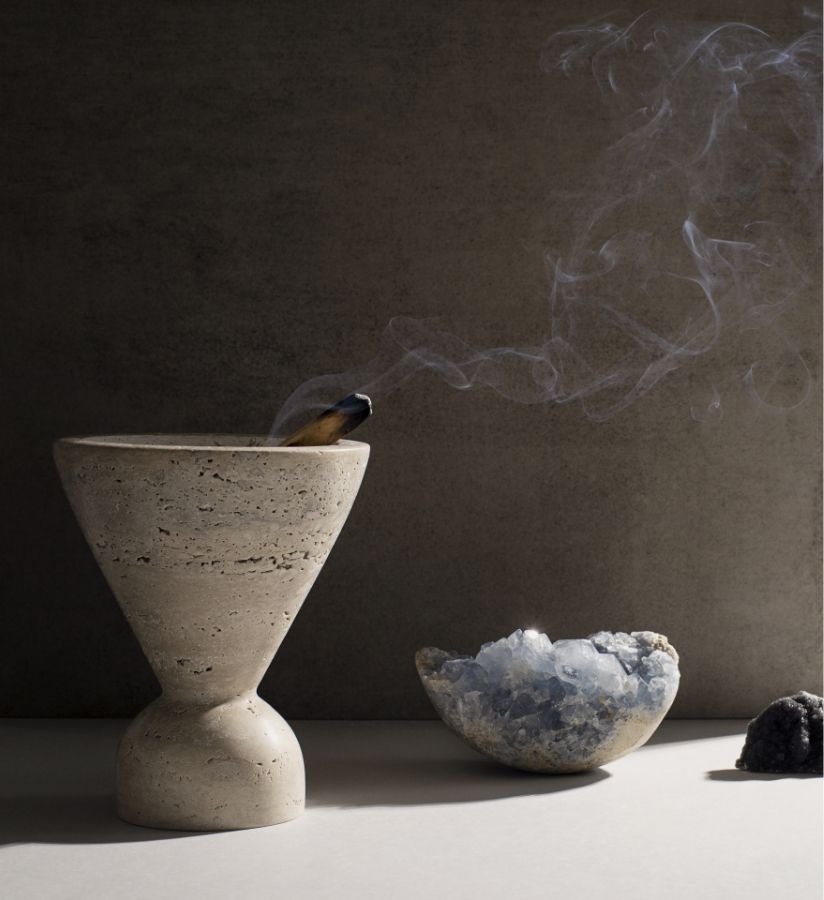 The New Moon’s Guide to Cleansing and Choosing crystals, still life photography by Amanda Kho, still life of burning palo santo with smoke drifting off, with celestite