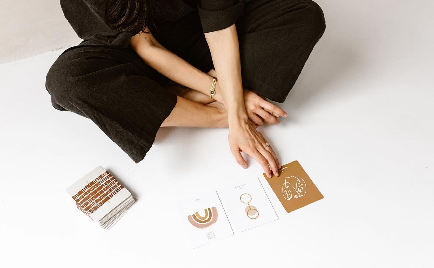 A woman playing with the Inner Compass Love Cards 