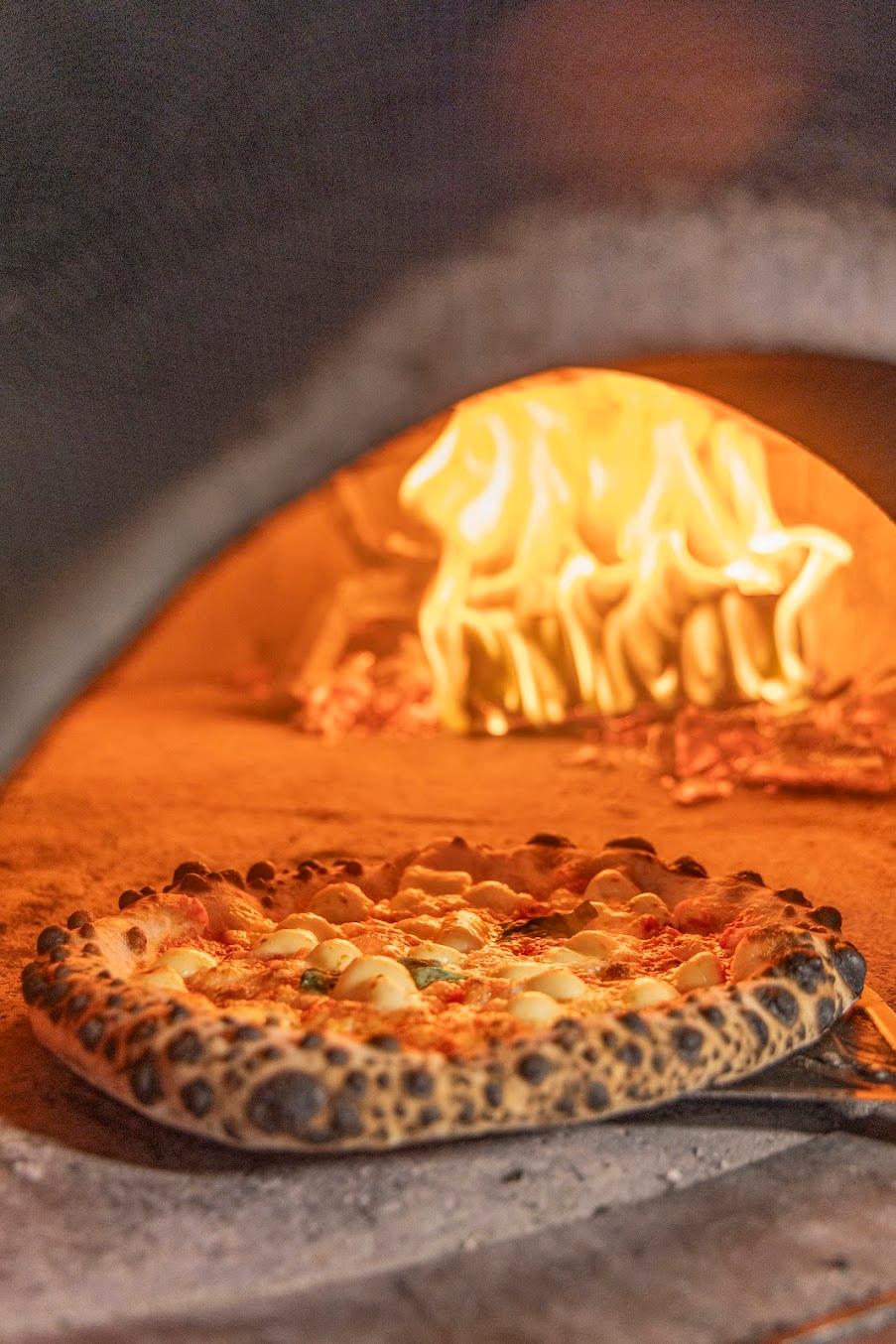 A pizza baking in the wood-fired oven at Fired Up Pizza Cornelscourt