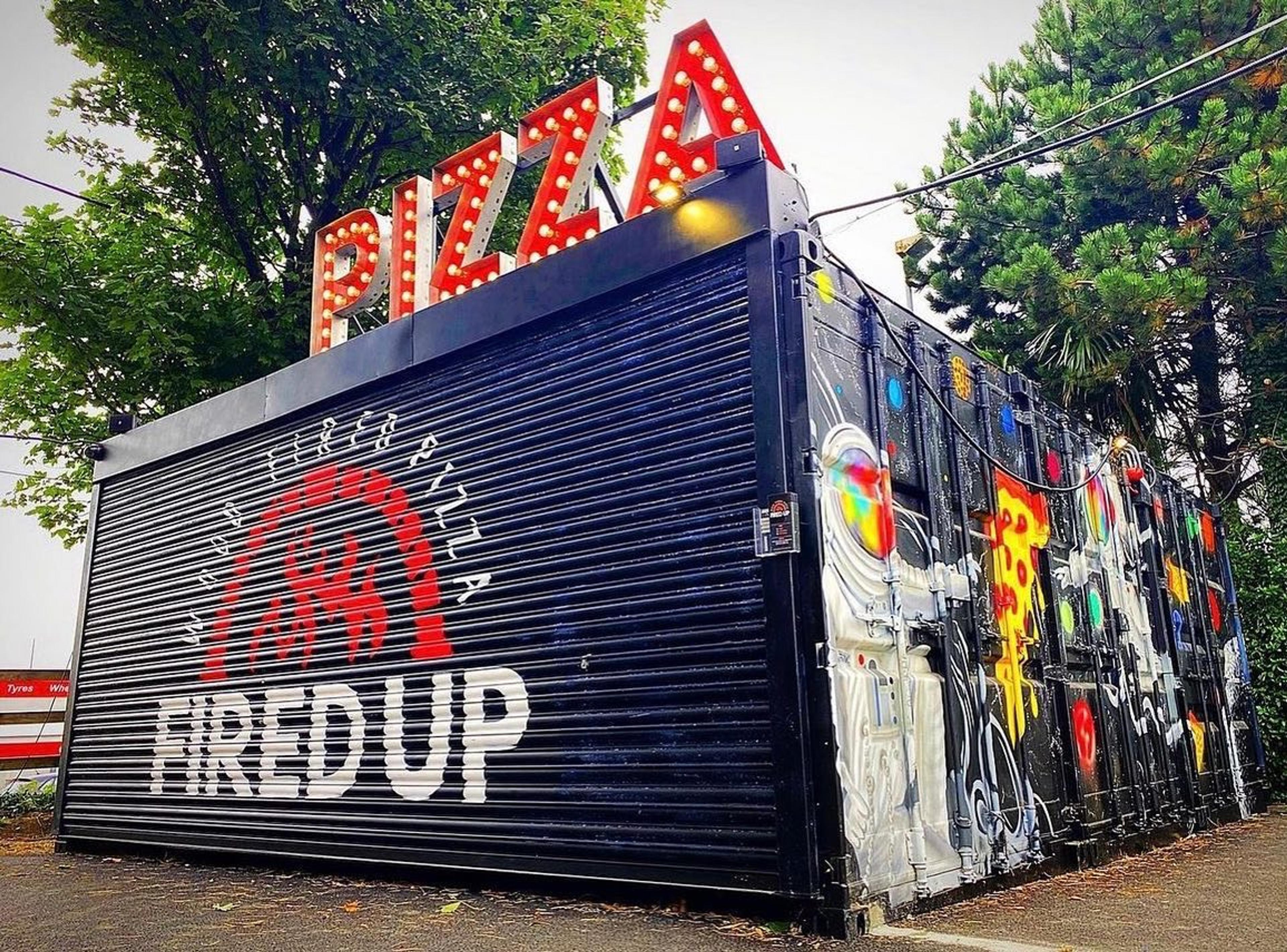 The Fired Up Pizza shipping container and pizza sign in Goatstown