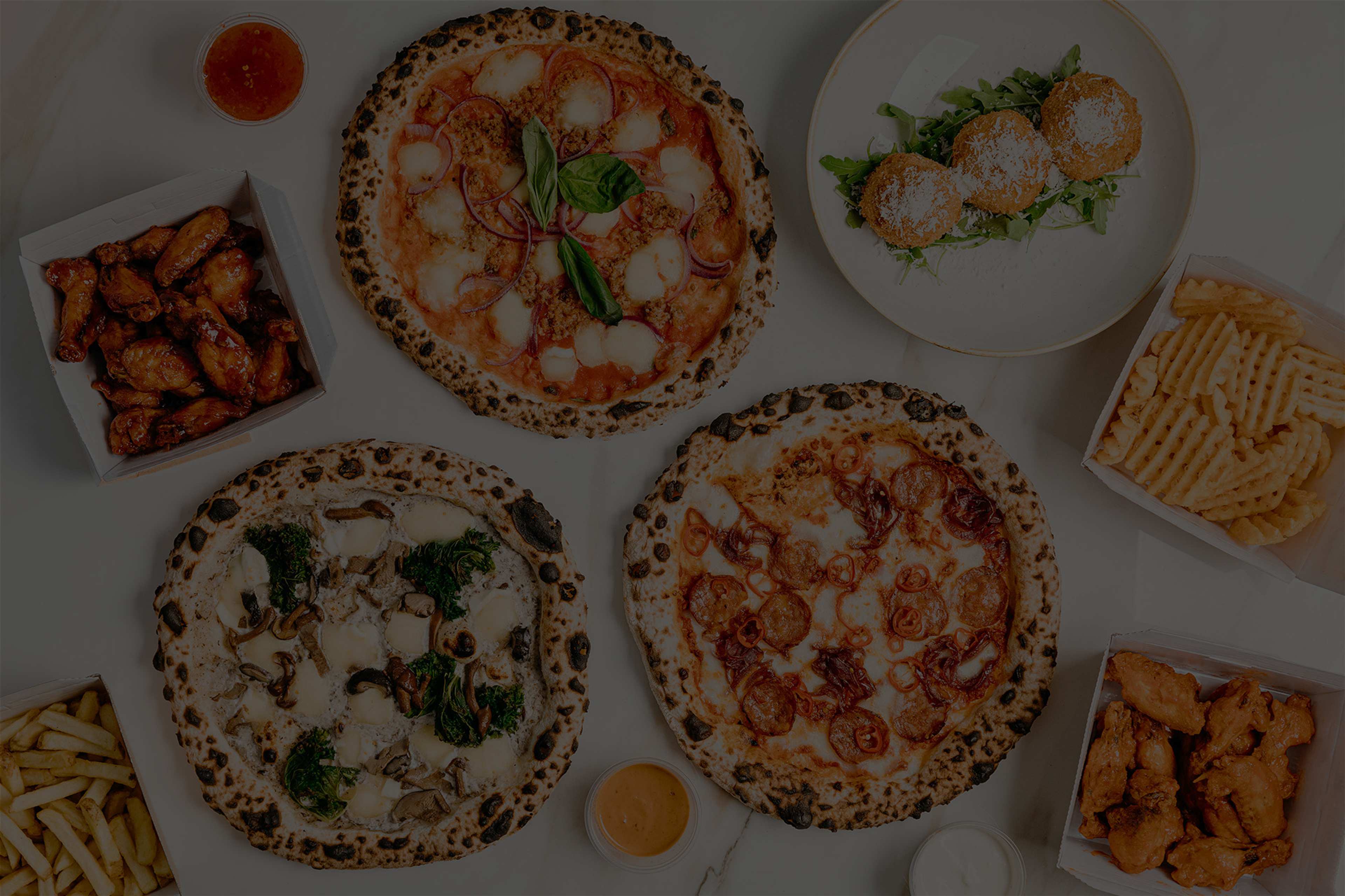 Pizzas, wings, arancini and waffle chips from Fired Up Pizza