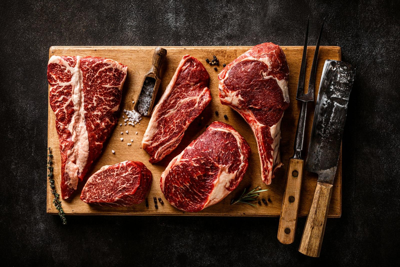 Raw steaks on a board