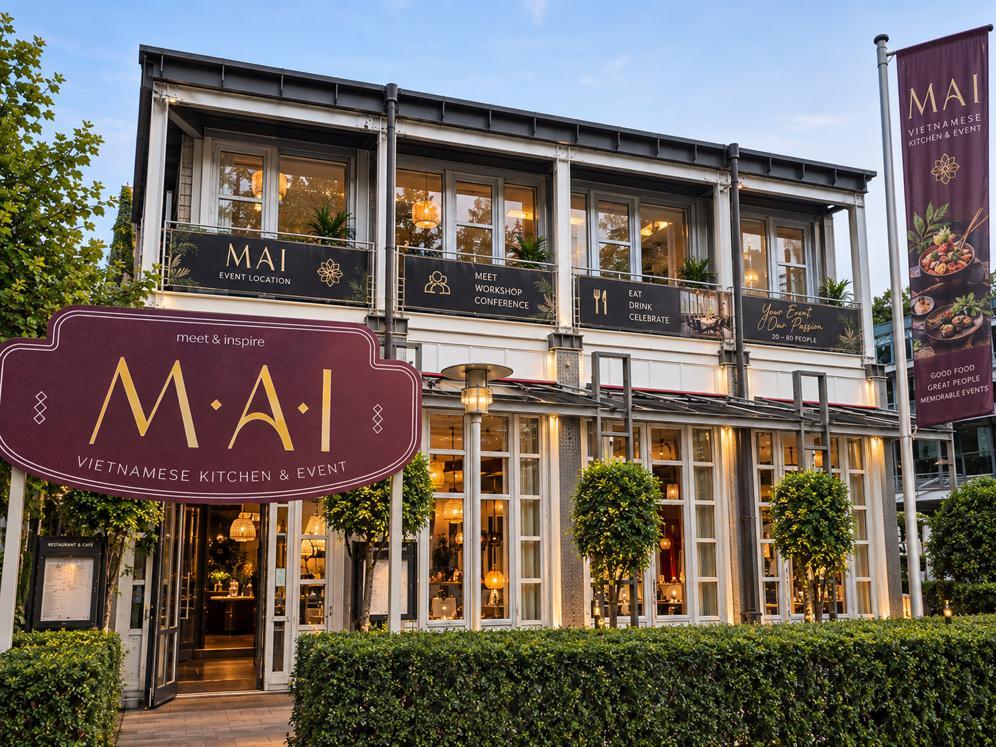 MAI storefront with signage, large windows, entrance, balcony with plants, and burgundy banner.