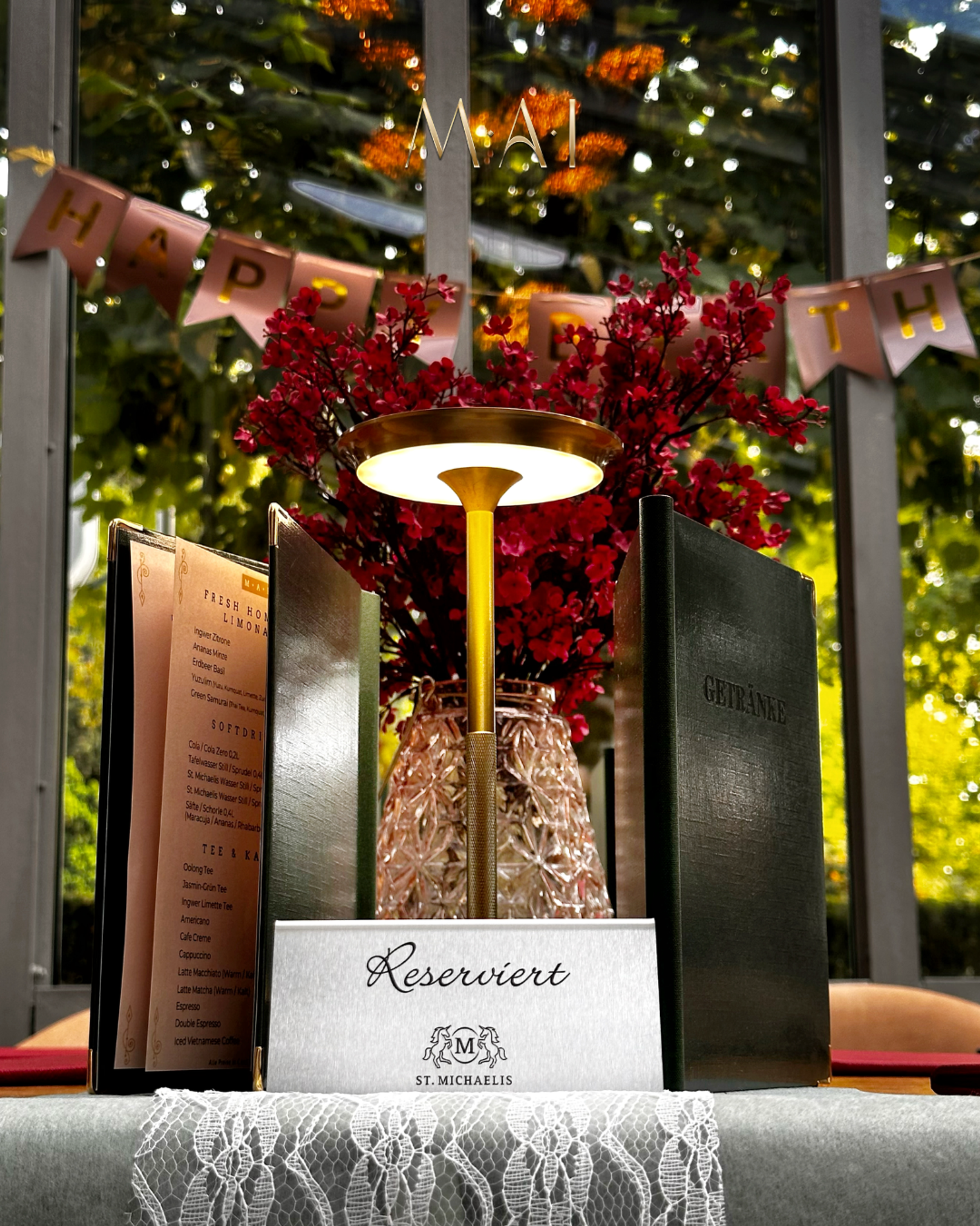 Hands holding glasses of prosecco. Table set with fruit, pastries, candles and decorations.