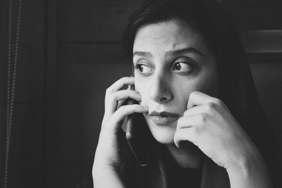 Worried woman on phone, highlighting client anxiety in personal injury case management