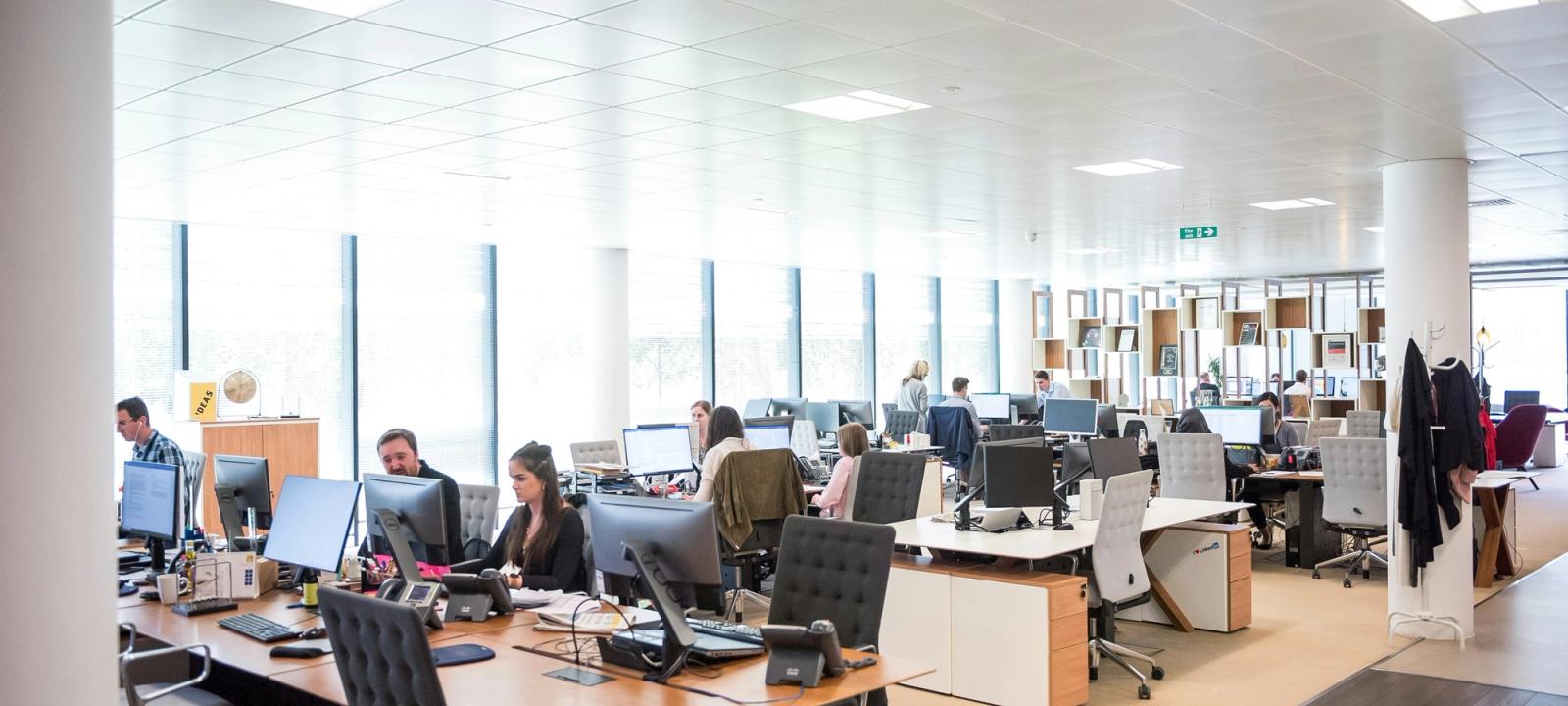 Busy office floor with headset agents representing an outsourced legal support team