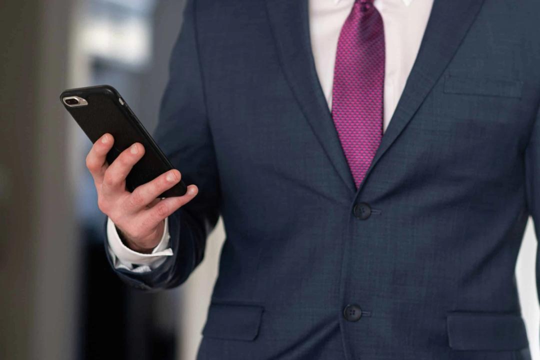 Attorney in suit checking case updates on a mobile phone