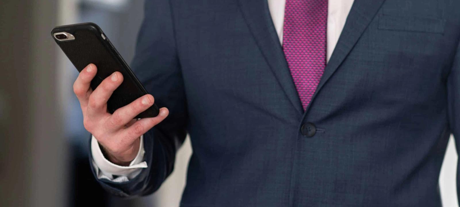 Attorney in suit checking case updates on a mobile phone