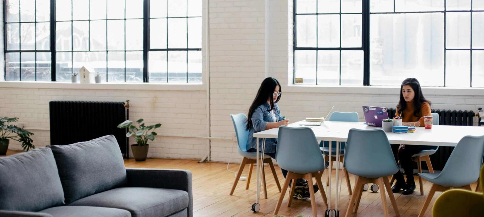 People working together at a desk for legal technology comparison between Quilia and Finch