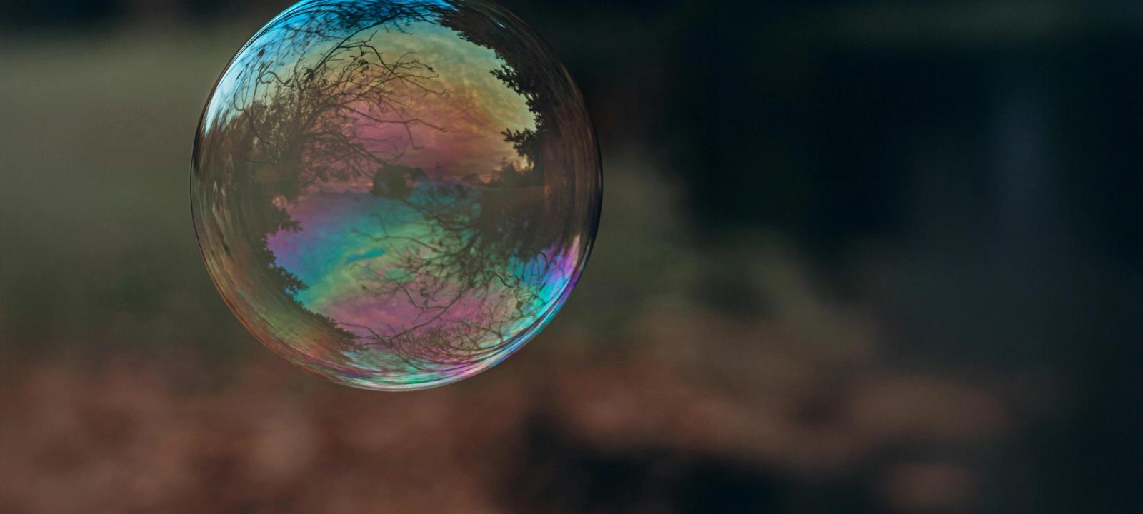 A close-up photo of a soap bubble symbolizing the fragility of the AI bubble in LegalTech.