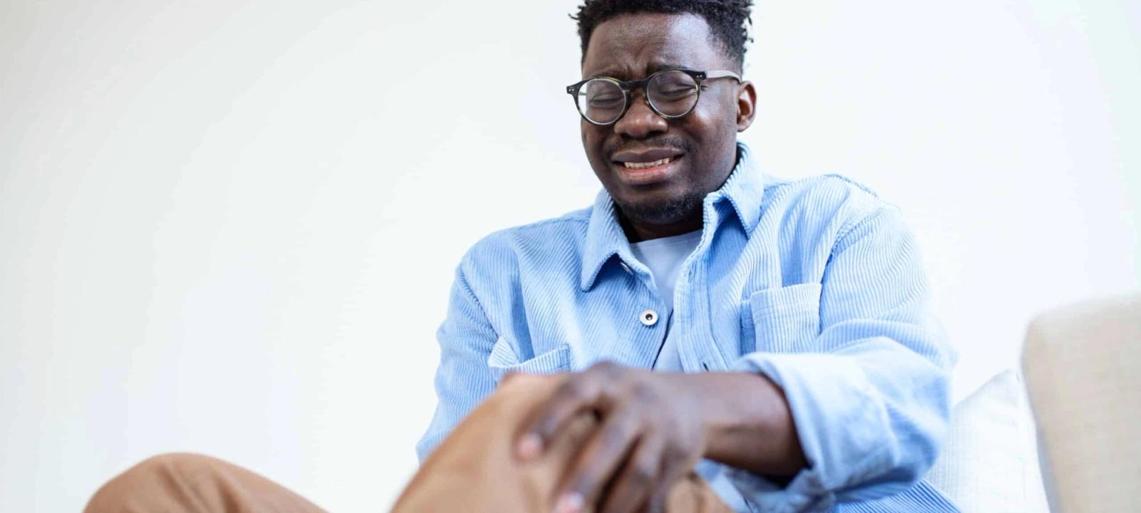 Man in pain using Quilia app to document pain levels for personal injury case