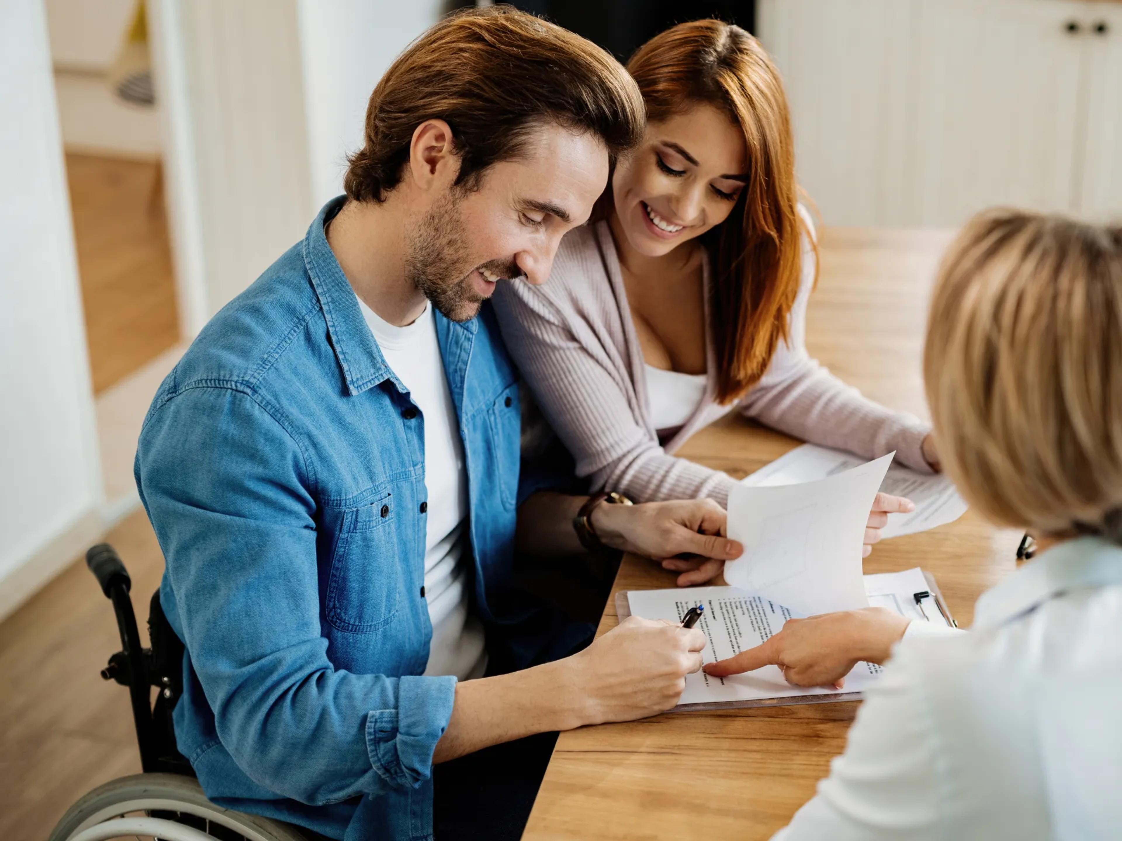 A photo of a man sitting in a wheelchair.