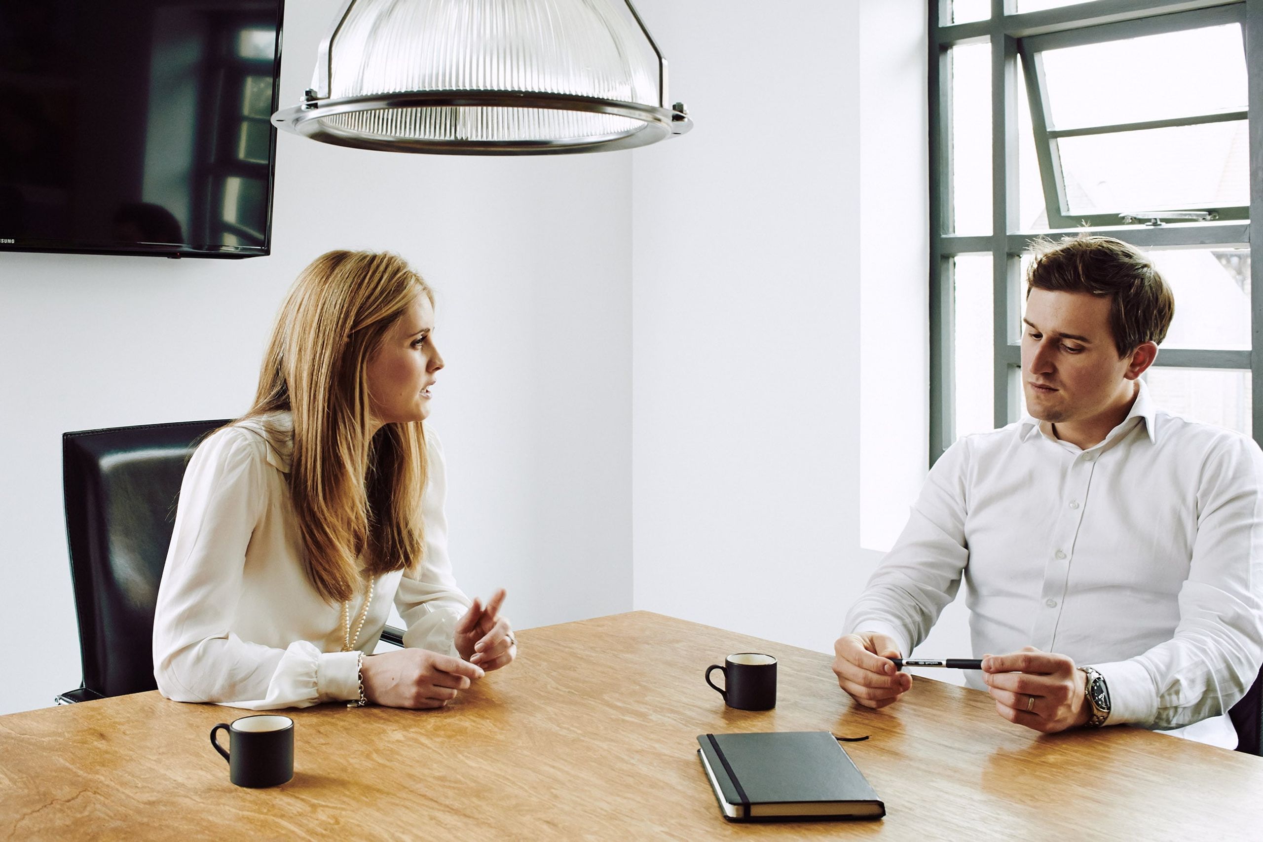 Woman and man discussing at meeting room table