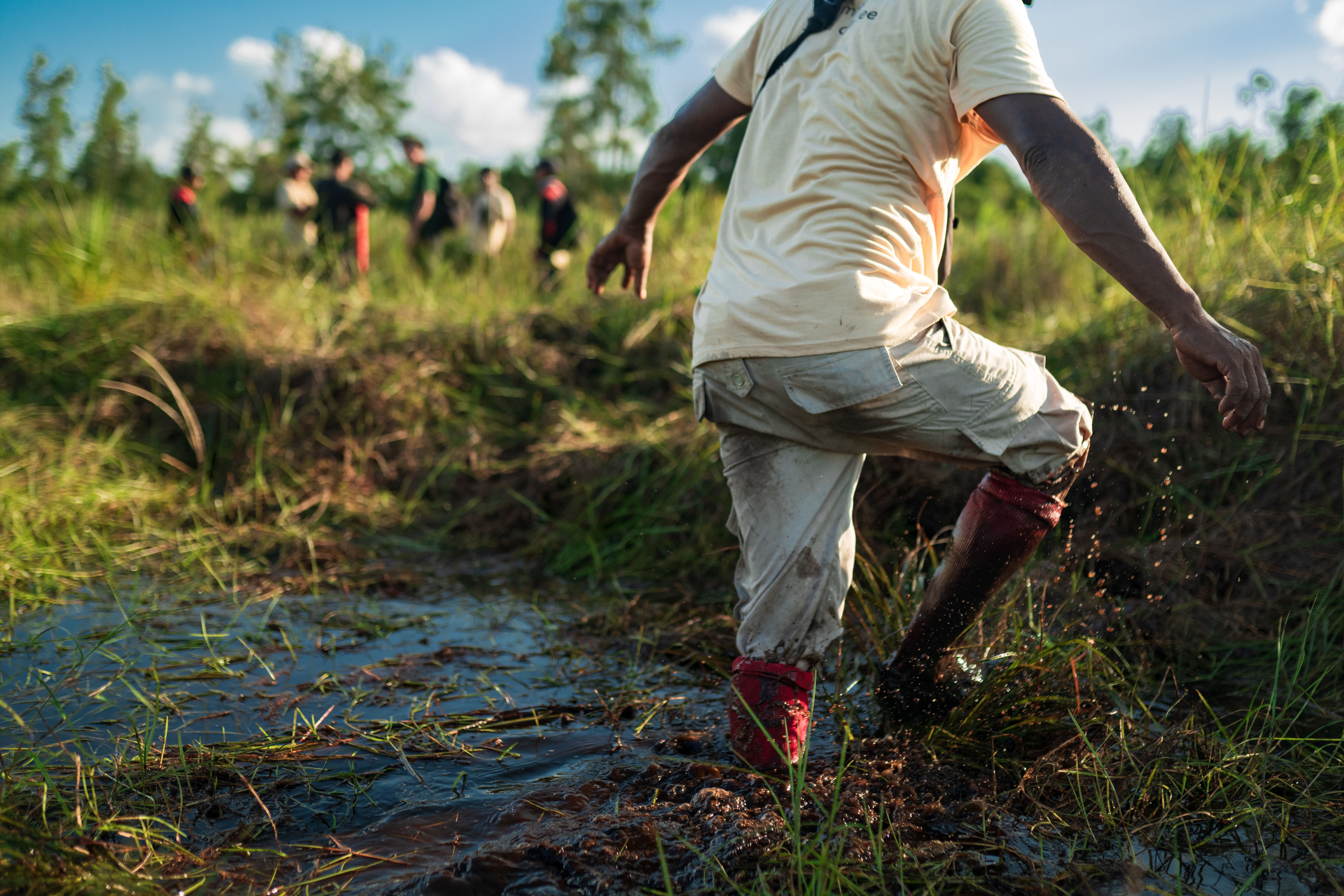 man stepping out of river in restoration site