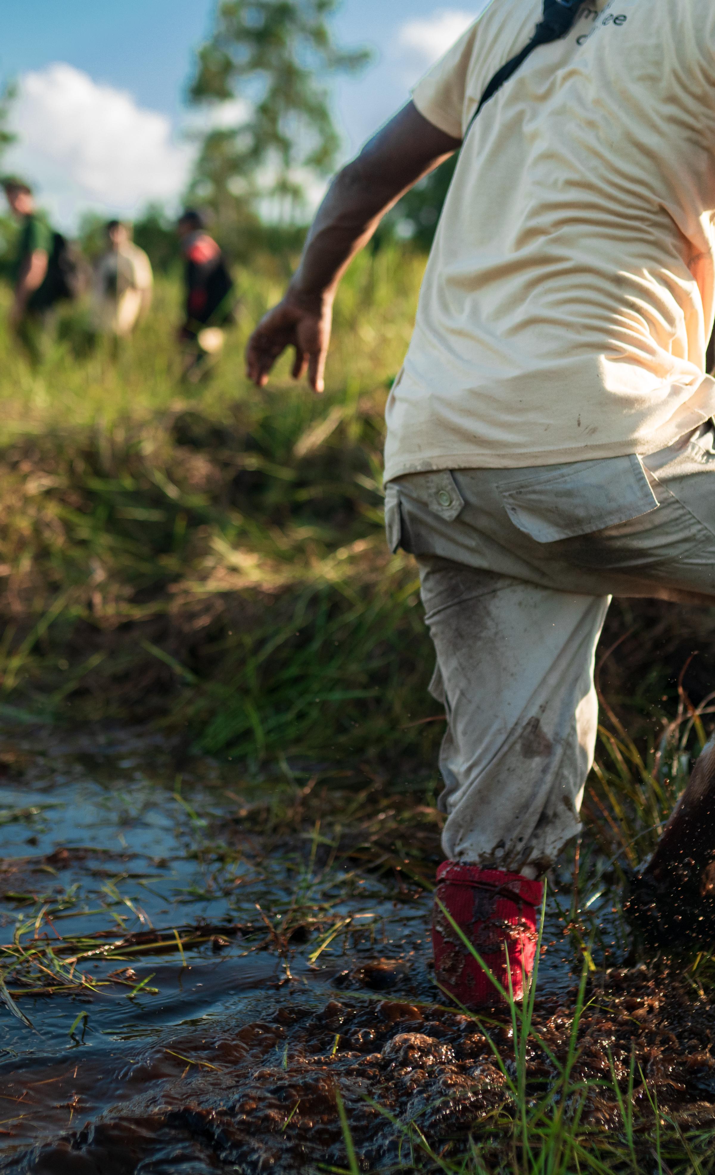 man stepping out of river in restoration site