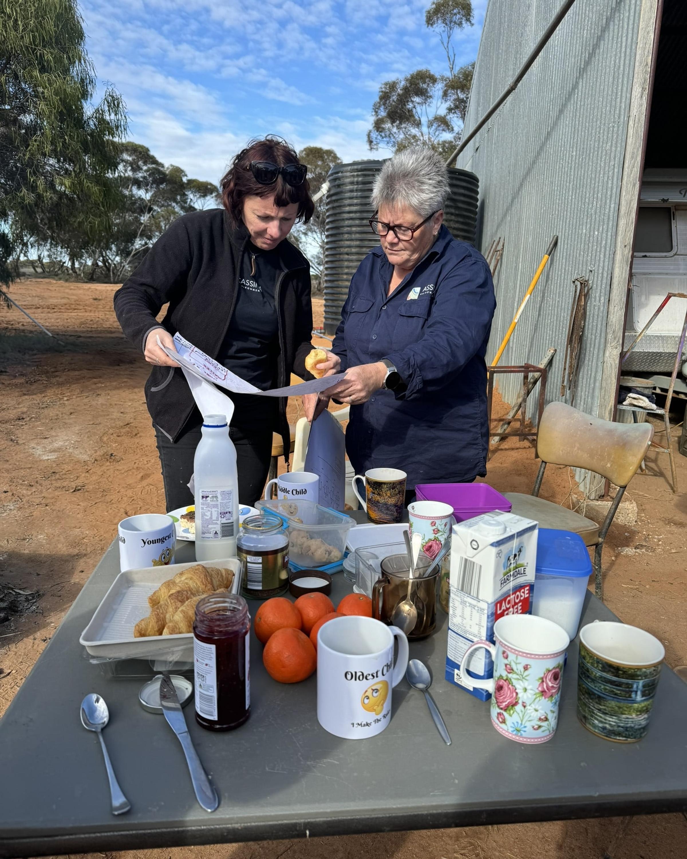 Two women looking at map on outback property in Victoria