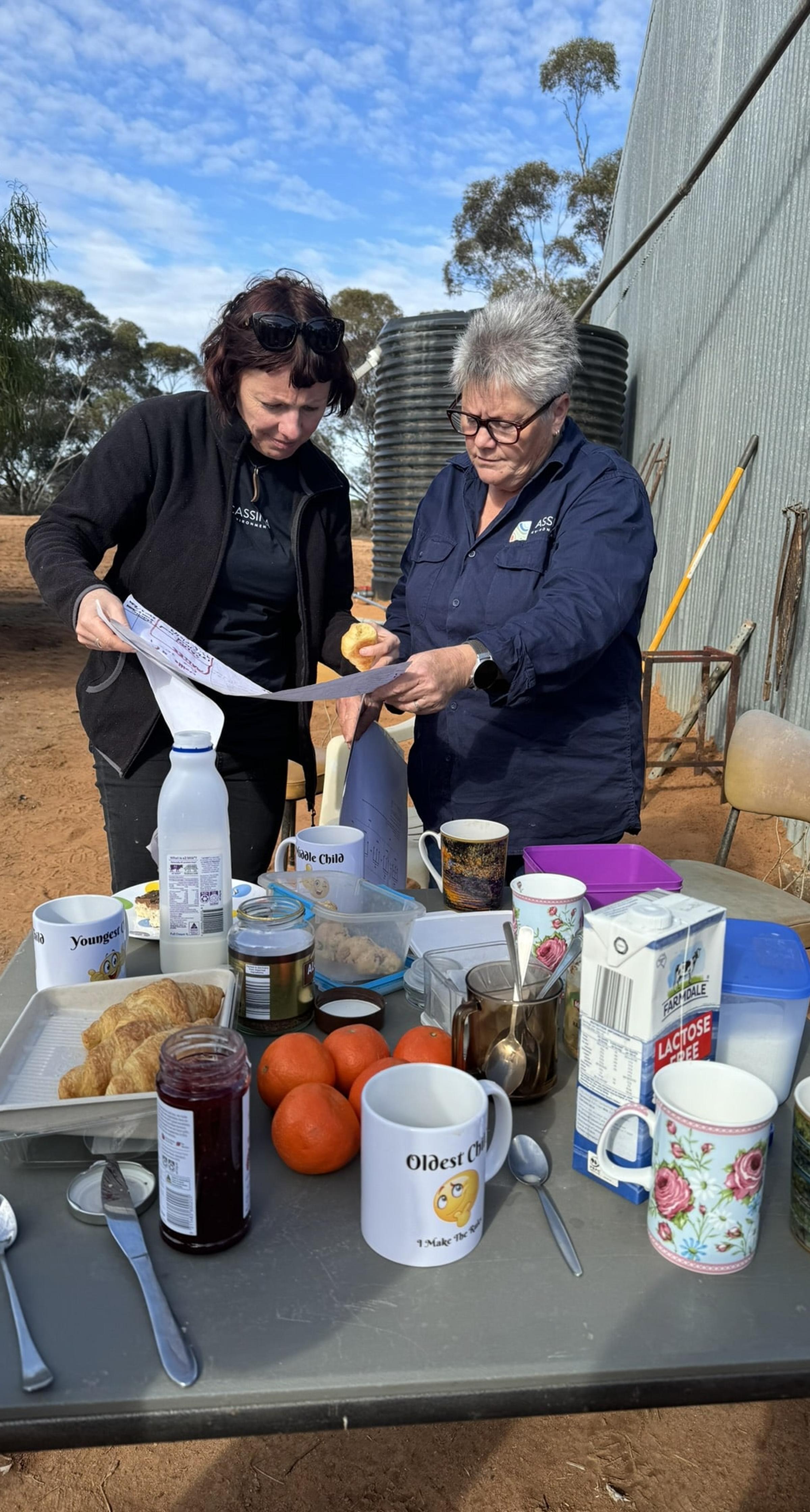 Two women looking at map on outback property in Victoria