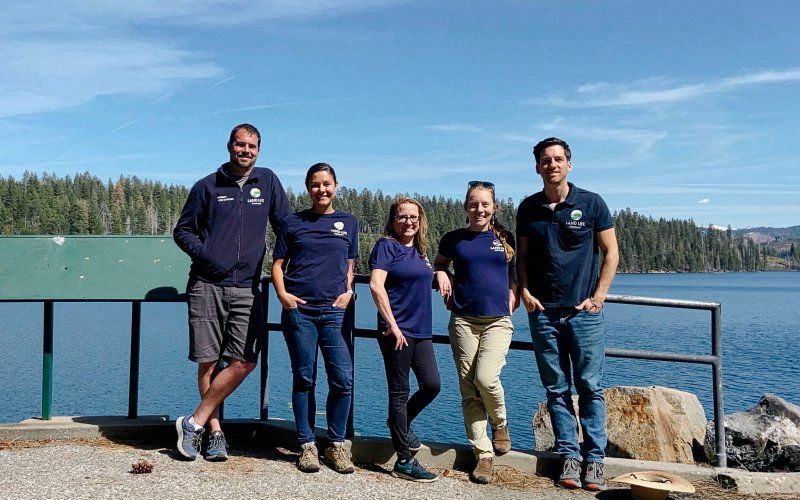 Crew standing in front of a lake