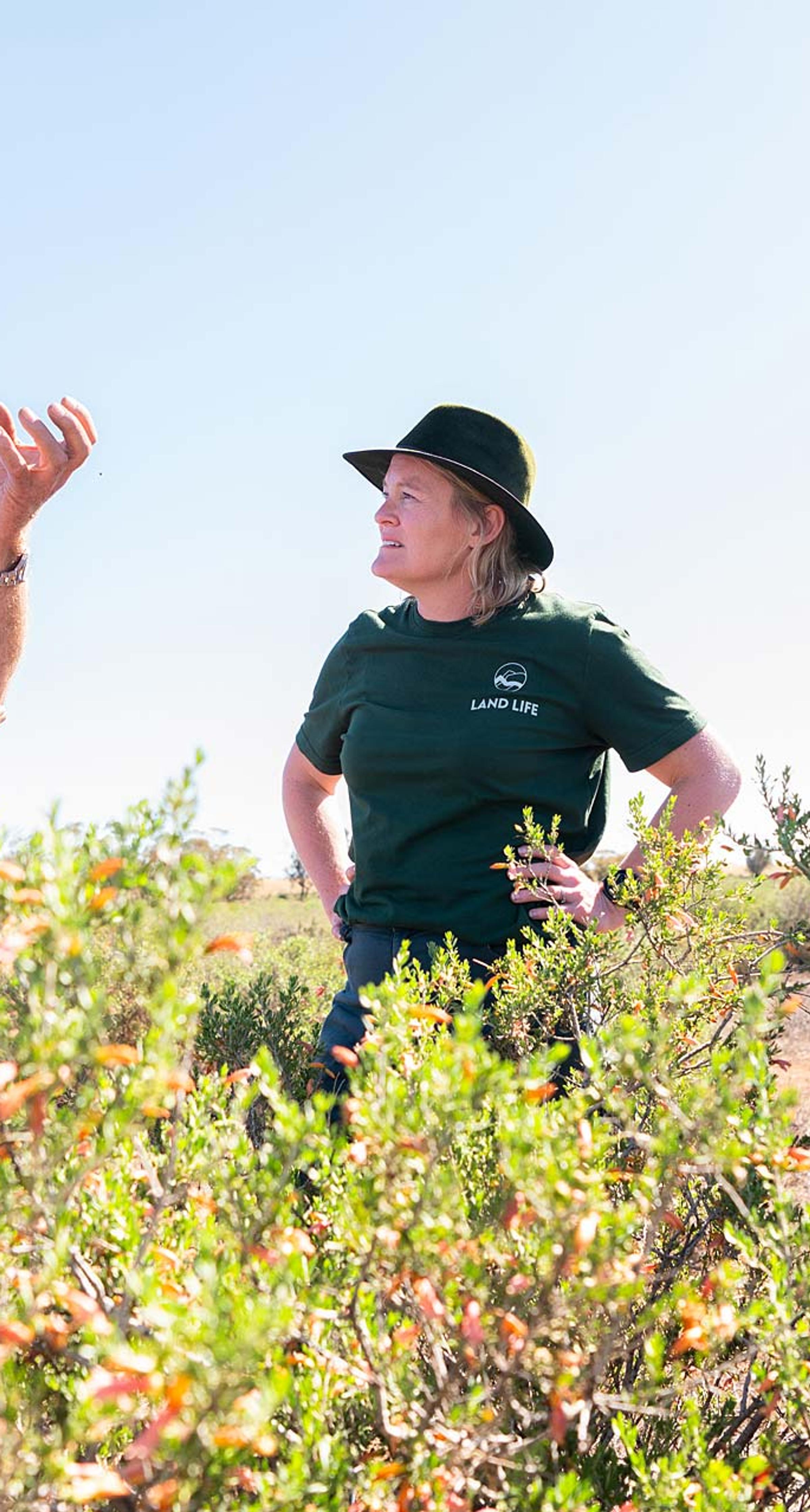 Two farmers and woman in Australian outback talking