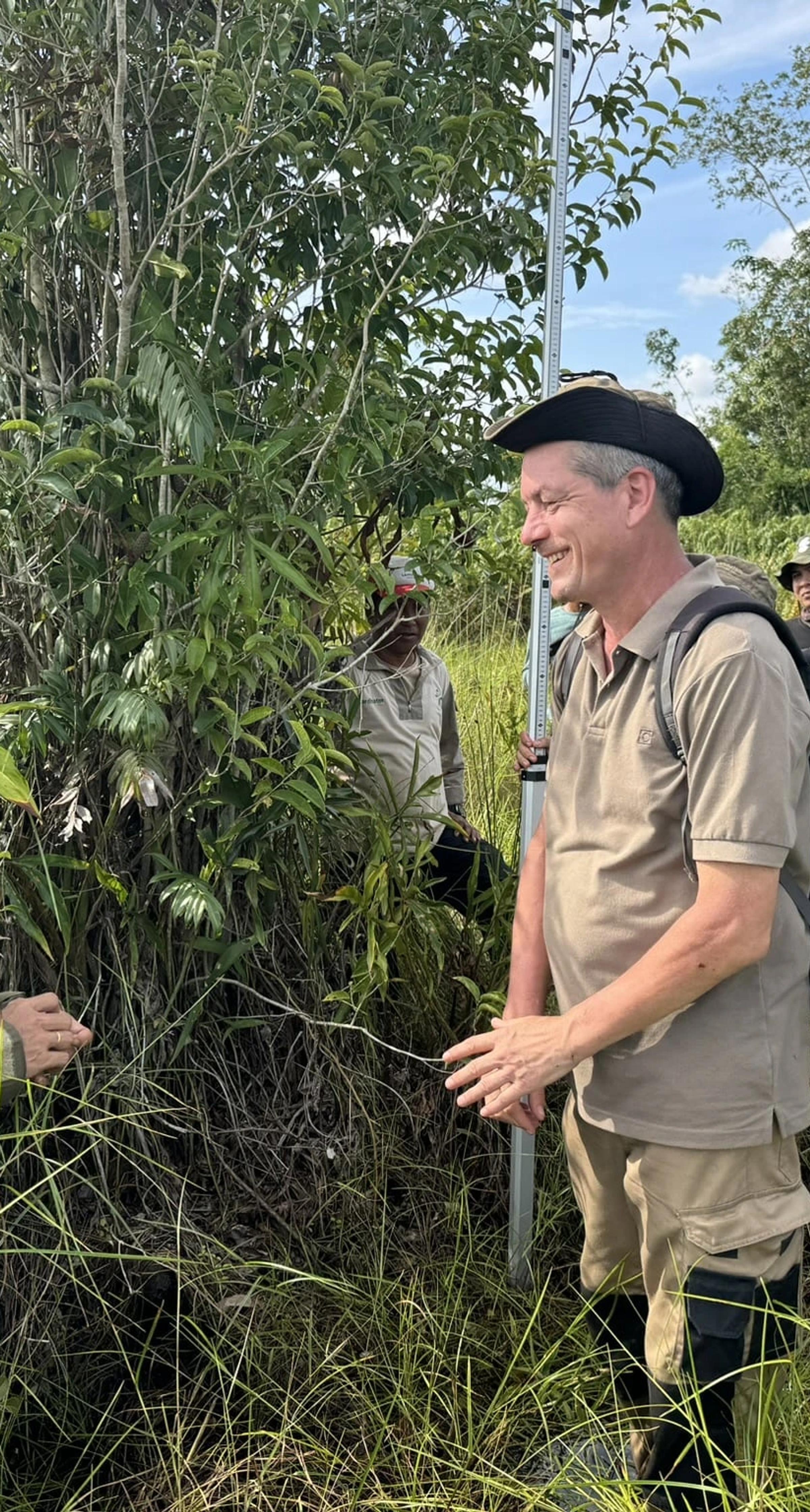 Indonesian locals in reforestation site with Land Life employee