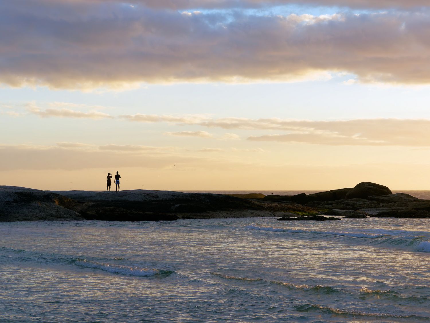 A couple enjoying an evening on one of the beatiful beaches around Cape Town, South Africa