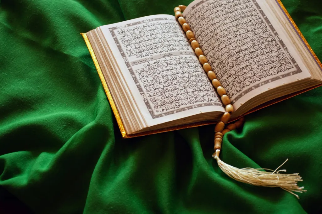 Picture of a Koran on a green carpet