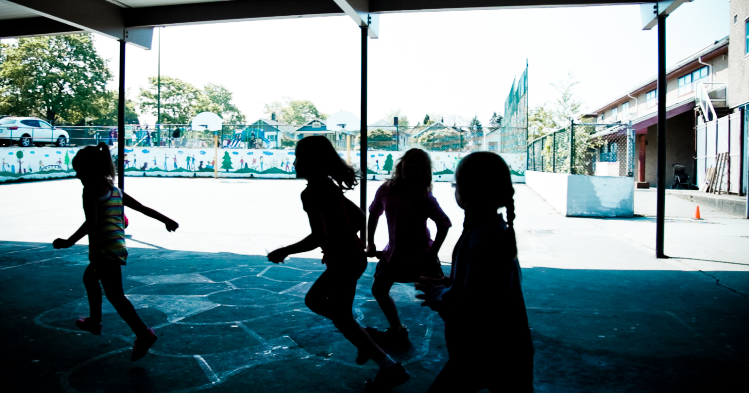 Silhouettes of children running and playing