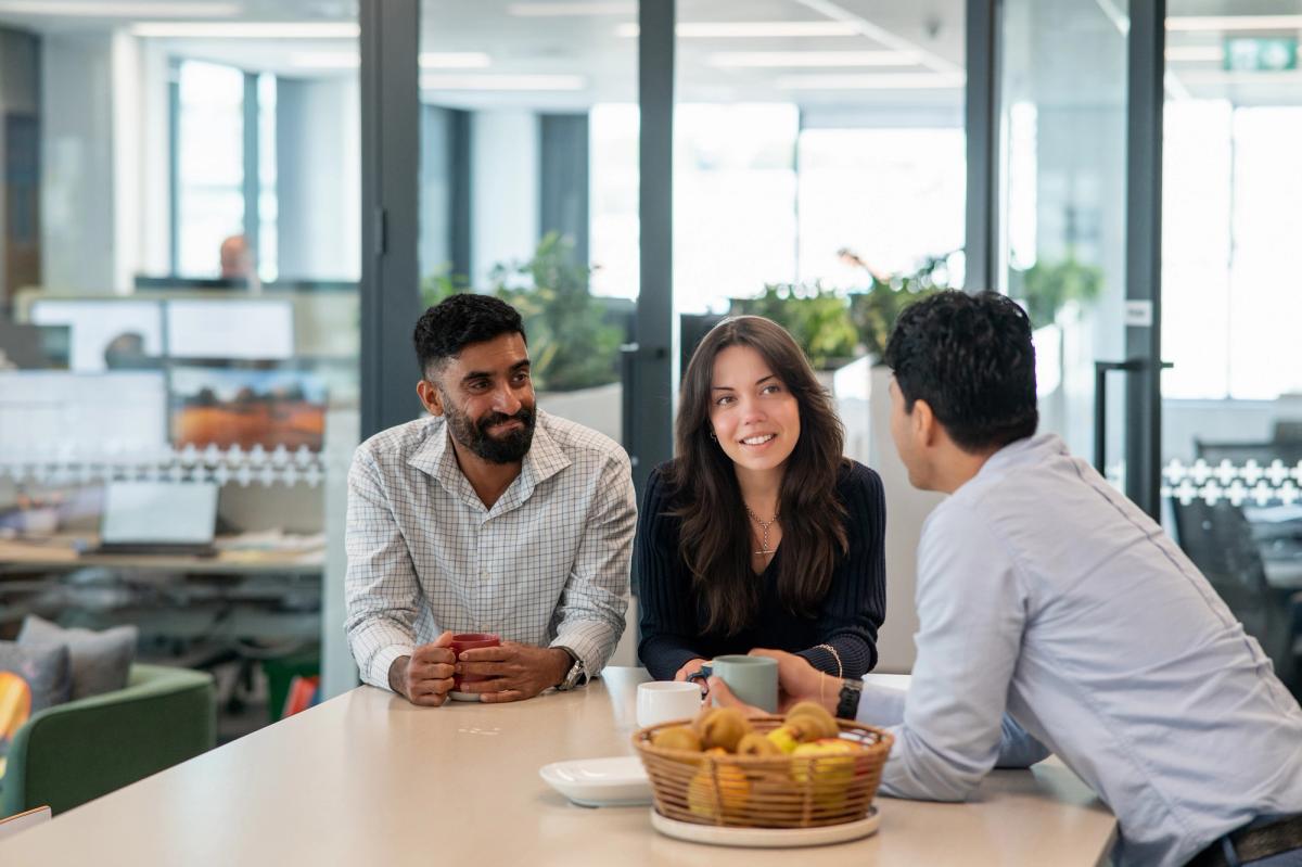 Group of people in discussion around a table, representing collaboration and purpose-led investment decisions. Group of people in discussion around a table, representing collaboration and purpose-led investment decisions.