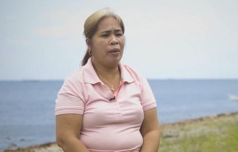 Participant in a Nuveen Orange Bond case study speaking outdoors near a coastal location in Southeast Asia.