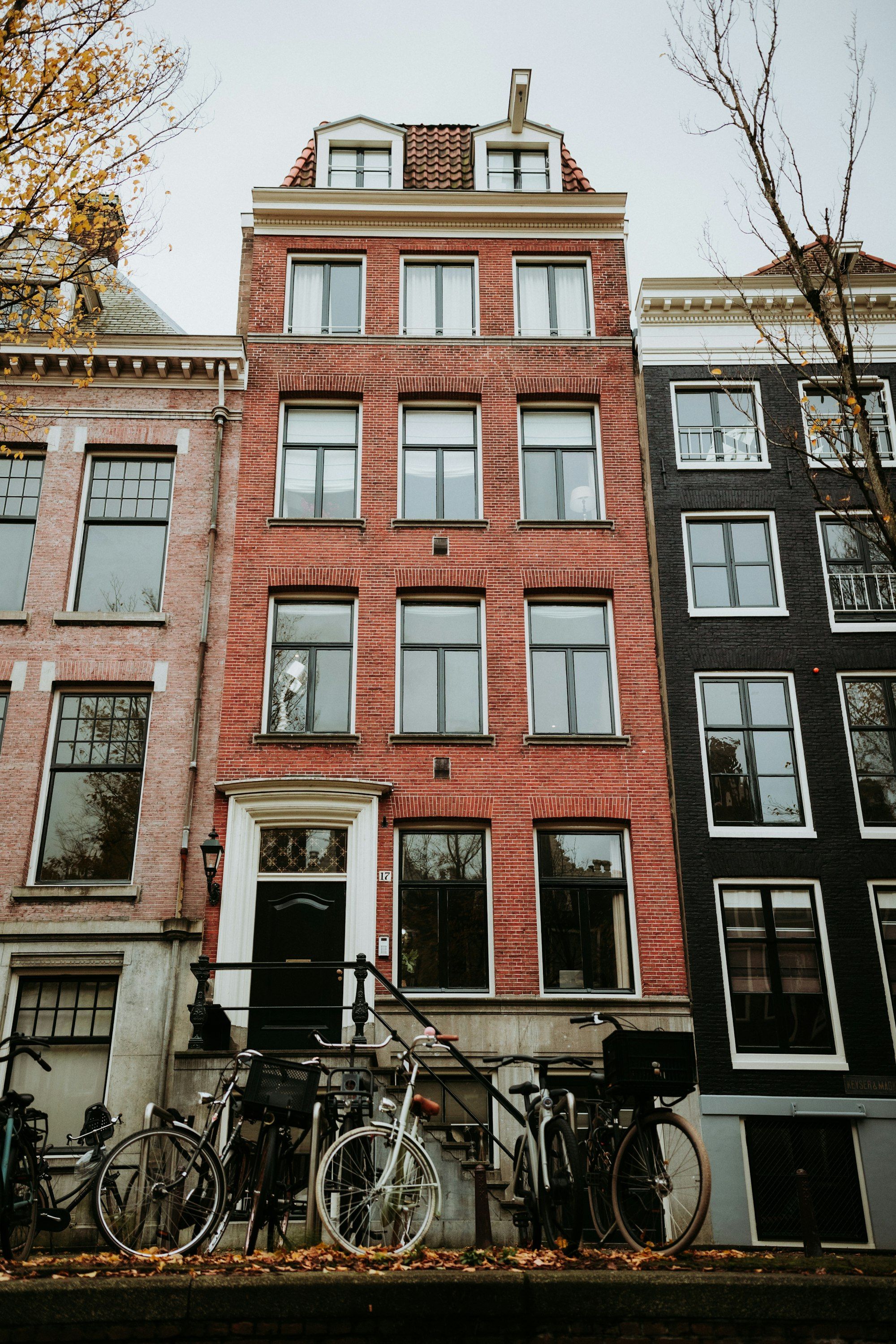 Colorful canal houses with bicycles parked out front in Amsterdam