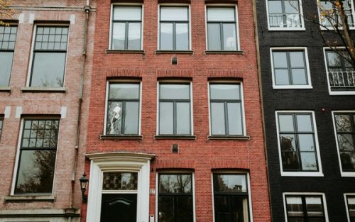 Colorful canal houses with bicycles parked out front in Amsterdam