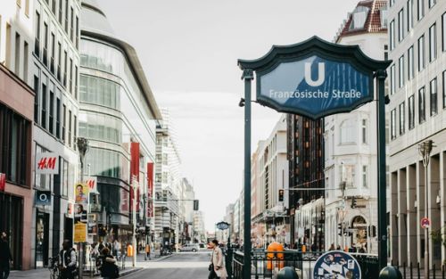 A city street with people walking on the sidewalk in Berlin